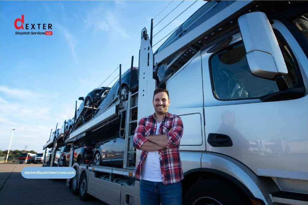 Truck driver standing in front of car hauler trailer – Dexter Dispatch Services
